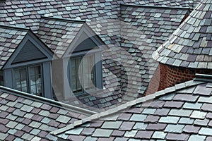 Closeup of slate tiled roofs in shades of grey and green