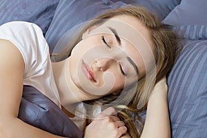 Closeup - Sleep. Young Woman Sleeping In Bed. Portrait Of Beautiful Female Resting On Comfortable Bed With Pillows In Bedding In