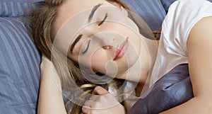 Closeup - Sleep. Young Woman Sleeping In Bed. Portrait Of Beautiful Female Resting On Comfortable Bed With Pillows In Bedding In
