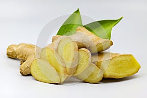 Closeup sliced Ginger with ginger root and green leaves Isolated on white background