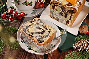 Closeup of sliced poppy seed cake with icing for Christmas on rustic style table