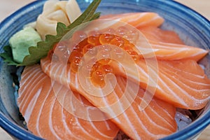 Closeup Sliced salmon top with Ikura decorated with green Shiso and fresh wasabi served at local Japanese restaurant. Popular