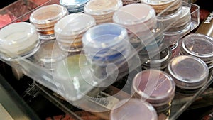 Closeup slow motion video of assortment of cosmetics, shades, paints and cremes in professional makeup artist studio