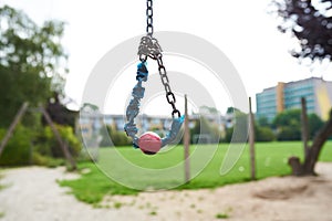 closeup of a small cable swing at a park playground