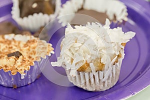 closeup of a small coconut cupcake in silver wrapping