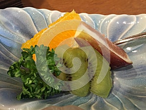 Closeup of small fruit platter with kiwi fruit, orange and passion fruit