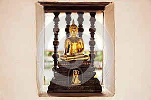 Closeup a small golden Buddha statue on wall of the temple. Believe, Culture of Asia, Traditional. Buddhist believe,