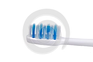 Closeup of small head toothbrush with soft slim tapered bristle