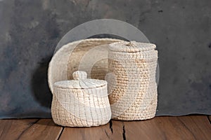 Closeup of small jute baskets with lids.