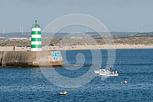 Closeup of small motorboats sailing along the Peniche sea in the district of Leiria, Portugal