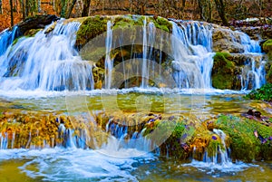 small waterfall on mountain river rushing through the mountain canyon