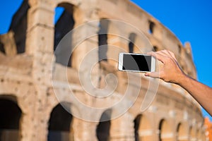 Closeup smart phone take the photo of Colosseum in Rome, Italy