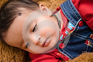 Closeup of Smiling baby lying on the bed