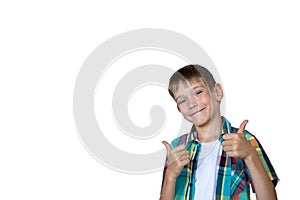 Closeup of smiling boy showing thumb up gesture isolated on white background, copy space. Joy, happiness concept
