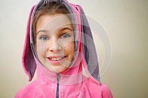 Closeup of smiling girl with flecks of sunlight in photo
