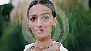 Closeup smiling girl looking camera outdoors. Portrait happy woman posing nature