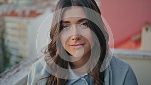 Closeup smiling girl looking camera in summer terrace. Portrait woman posing