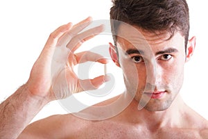 Closeup of smiling man holding pills