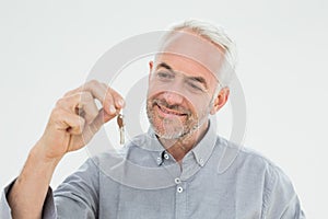 Closeup of a smiling mature man holding house keys