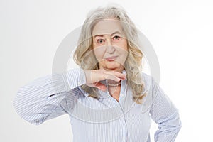 Closeup of smiling senior woman wrinkle face and gray hair. Old mature lady touching her wrinkled skin isolated on white