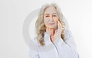 Closeup of smiling senior woman wrinkle face and gray hair. Old mature lady touching her wrinkled skin isolated on white