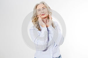 Closeup of smiling senior woman wrinkle face and gray hair. Old mature lady touching her wrinkled skin  on white