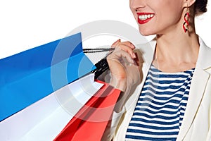 Closeup on smiling woman with French flag colours shopping bags