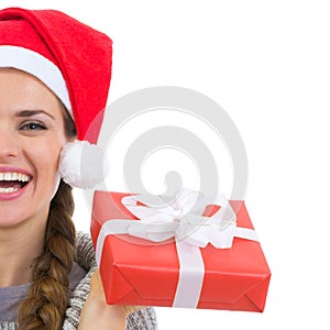 Closeup on smiling woman holding Christmas present