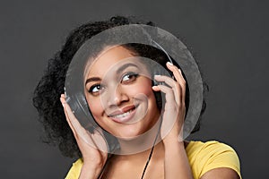 Closeup of a smiling woman listening music looking up