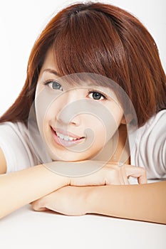 Closeup of smiling young woman lying prone