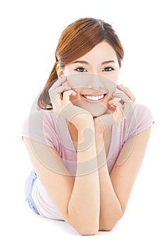 Closeup of smiling young woman lying prone on the floor photo