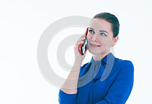 Close up of smiling young woman talking on cell phone looking to the side, over white background.