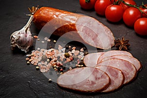 Closeup smoked ham sausage with tomatoes and garlic