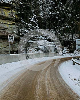 Closeup of a smooth road in the winter forest