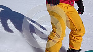 Closeup of Snowboarder on Ski Slope. Slow Motion