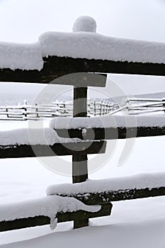 Closeup of snowy winter corral fences