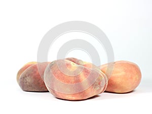 Closeup of snuffbox peaches against a white background