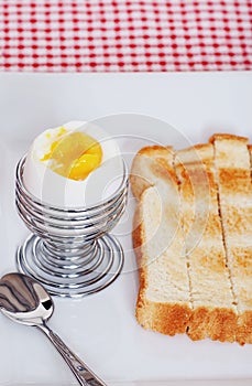 Closeup soft boiled egg with sliced toast