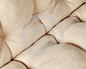 Closeup of soft window cushion of beige linen fabric