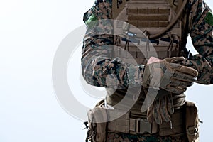 Closeup of soldier hands putting protective battle gloves