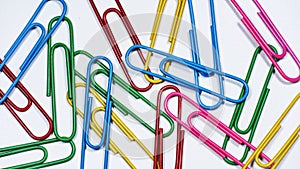 Closeup of assorted colorful paperclips isolated on white background