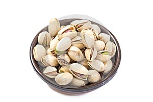 Closeup of some roasted pistachio in bowl over white background