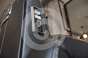 Closeup of some switches and an built in electrical outlet of a Barbers Chair at a salon or barbershop