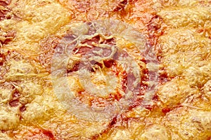 Closeup of soy sausage slices under melted vegetarian mozzarella on vegan pizza
