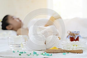 Closeup on spa therapy ingredients and relaxed young woman