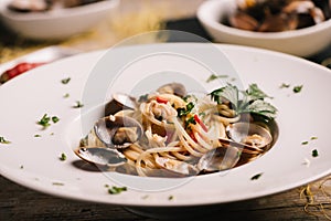 Closeup of spaghetti dish with clams on a white dish