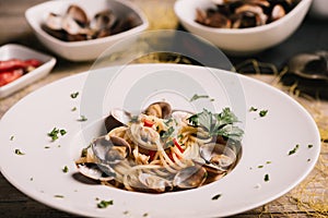 Closeup of spaghetti dish with clams on a white dish