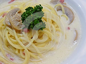 Closeup of Spaghetti with Mushroom Herb and Ham in white Creamy Sauce
