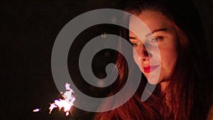 Closeup sparklers portrait of beautiful women celebrating a holiday