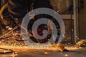 Closeup of sparks caused by worker welding metal